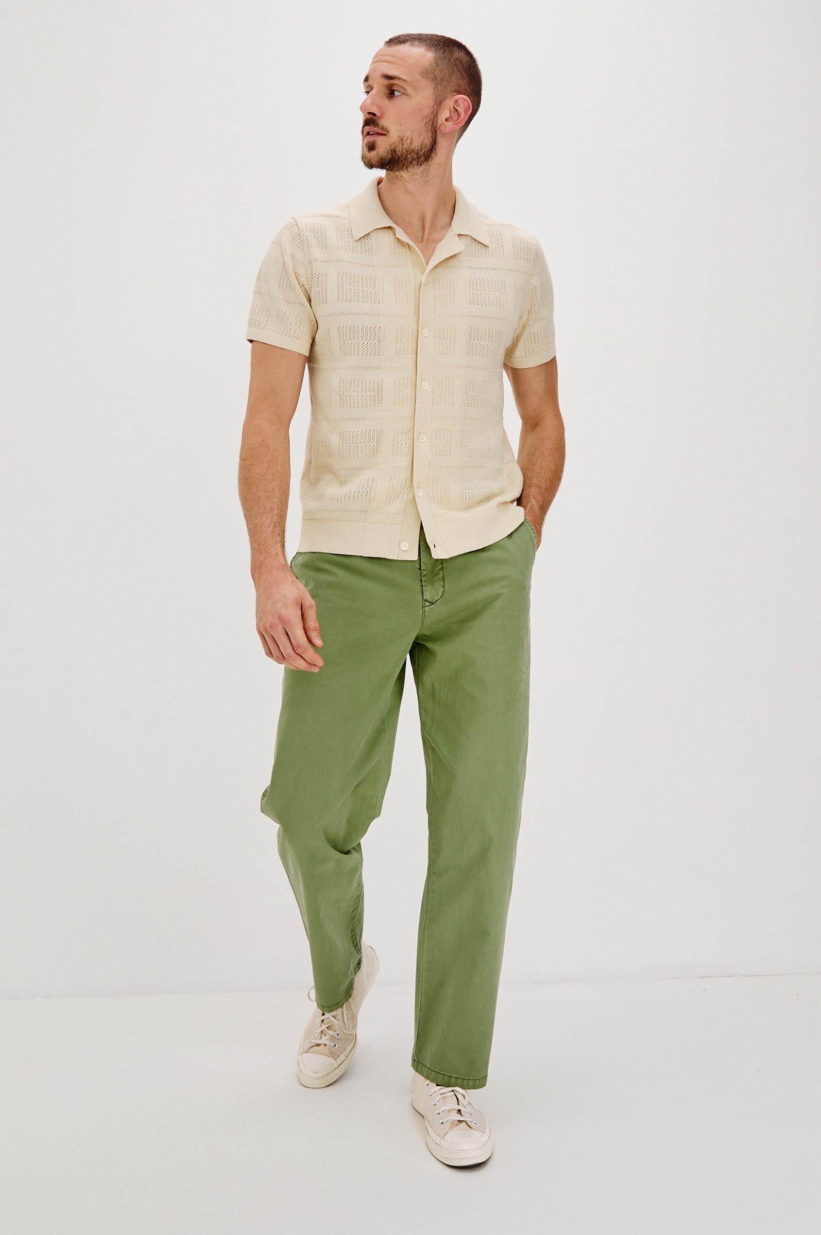 Yates Button Front Knit Shirt with Short Sleeves, a Relaxed Collar and Lapel, Ribbed Sleeve Cuff, Collar, Hem and Front Button Placket in Cream Colorway. Full Body Front View Shown on Model.