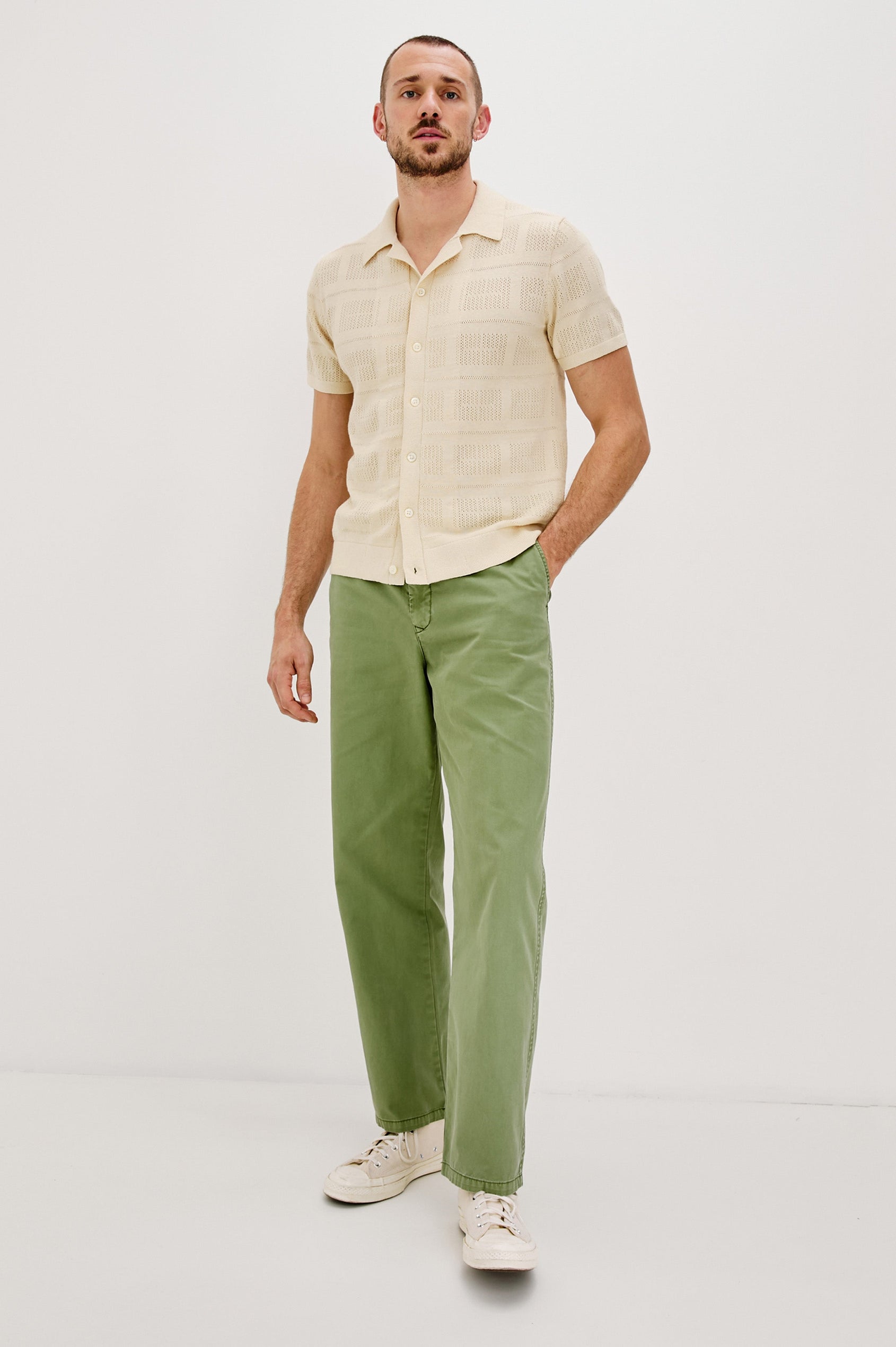 Yates Button Front Knit Shirt with Short Sleeves, a Relaxed Collar and Lapel, Ribbed Sleeve Cuff, Collar, Hem and Front Button Placket in Cream Colorway. Full Body Front View Shown on Model.