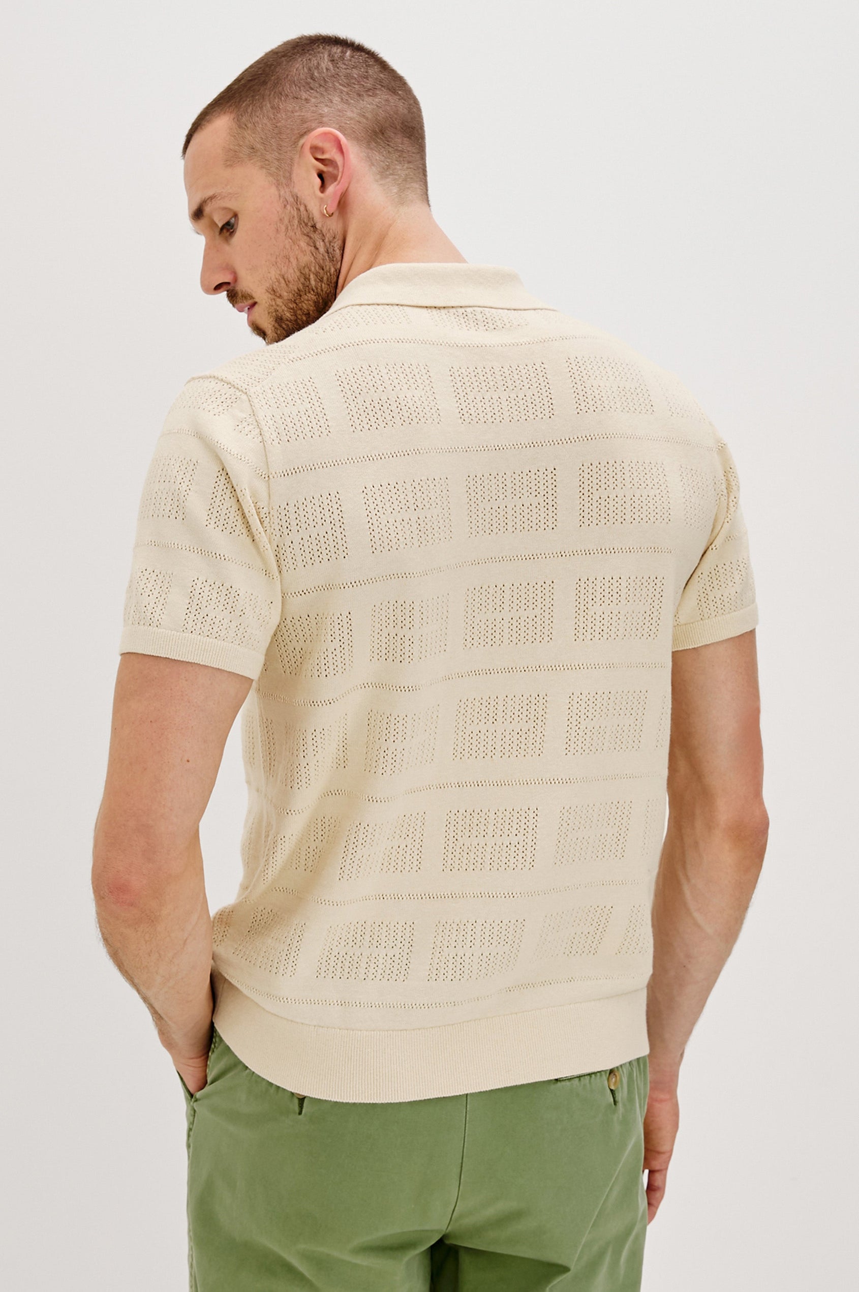 Yates Button Front Knit Shirt with Short Sleeves, a Relaxed Collar and Lapel, Ribbed Sleeve Cuff, Collar, Hem and Front Button Placket in Cream Colorway. Back View Shown on Model.