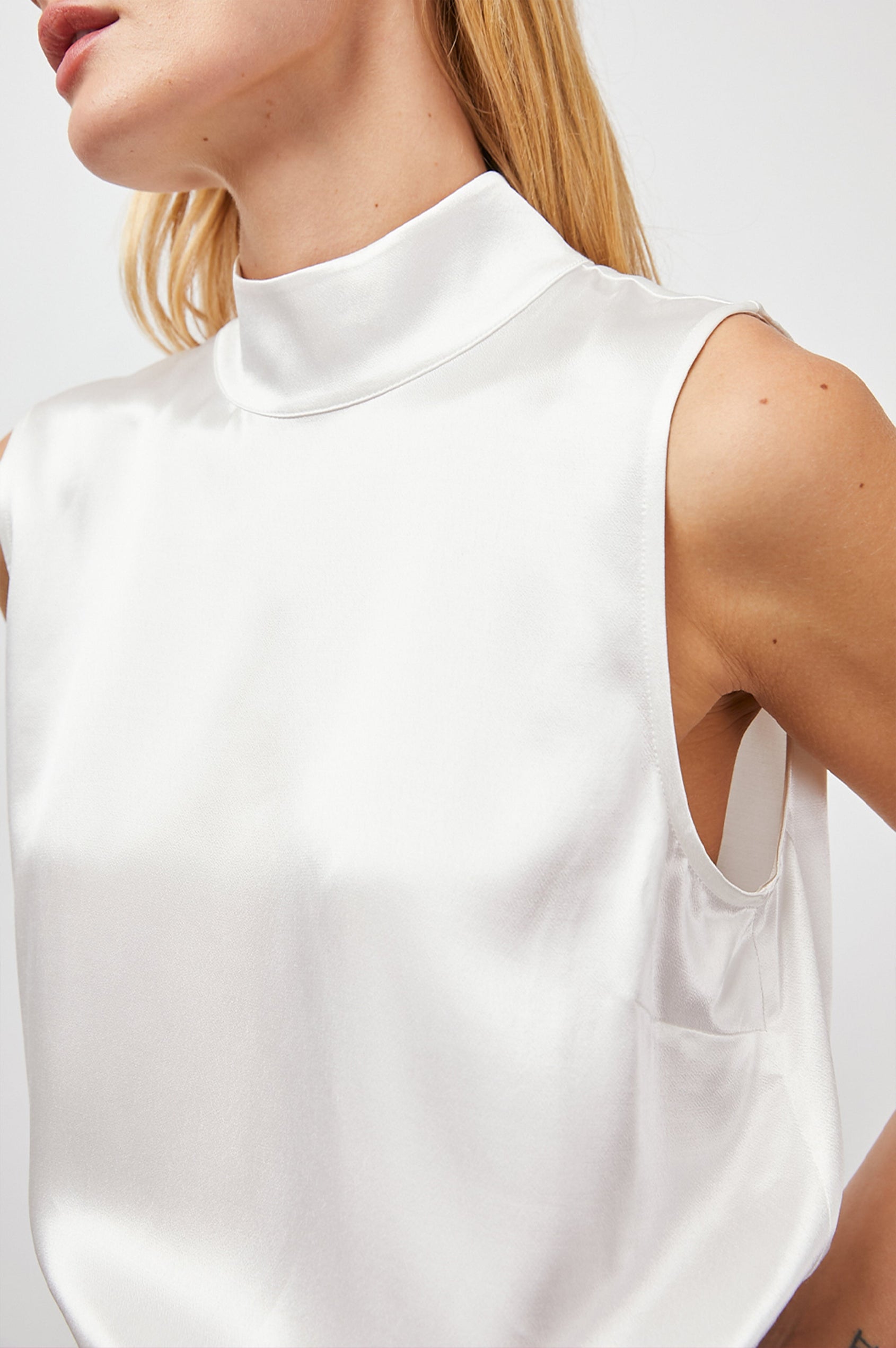 Yolie Sleeveless Tank Top with a Mock Neck and Two Button Back Neck Closure with a Keyhole in White Colorway - Front View Featured on Model