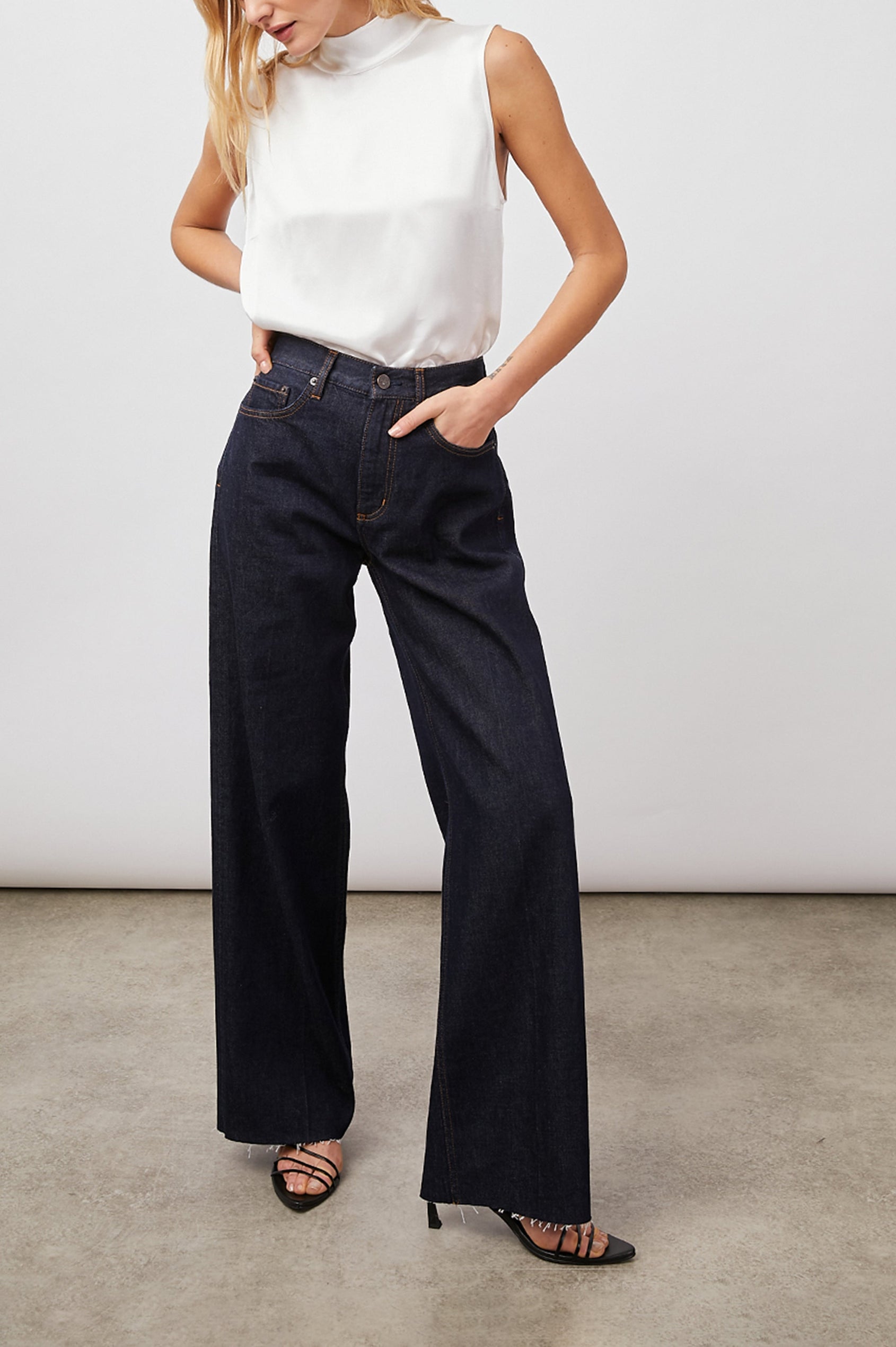 Yolie Sleeveless Tank Top with a Mock Neck and Two Button Back Neck Closure with a Keyhole in White Colorway - Front Full Body View Featured on Model