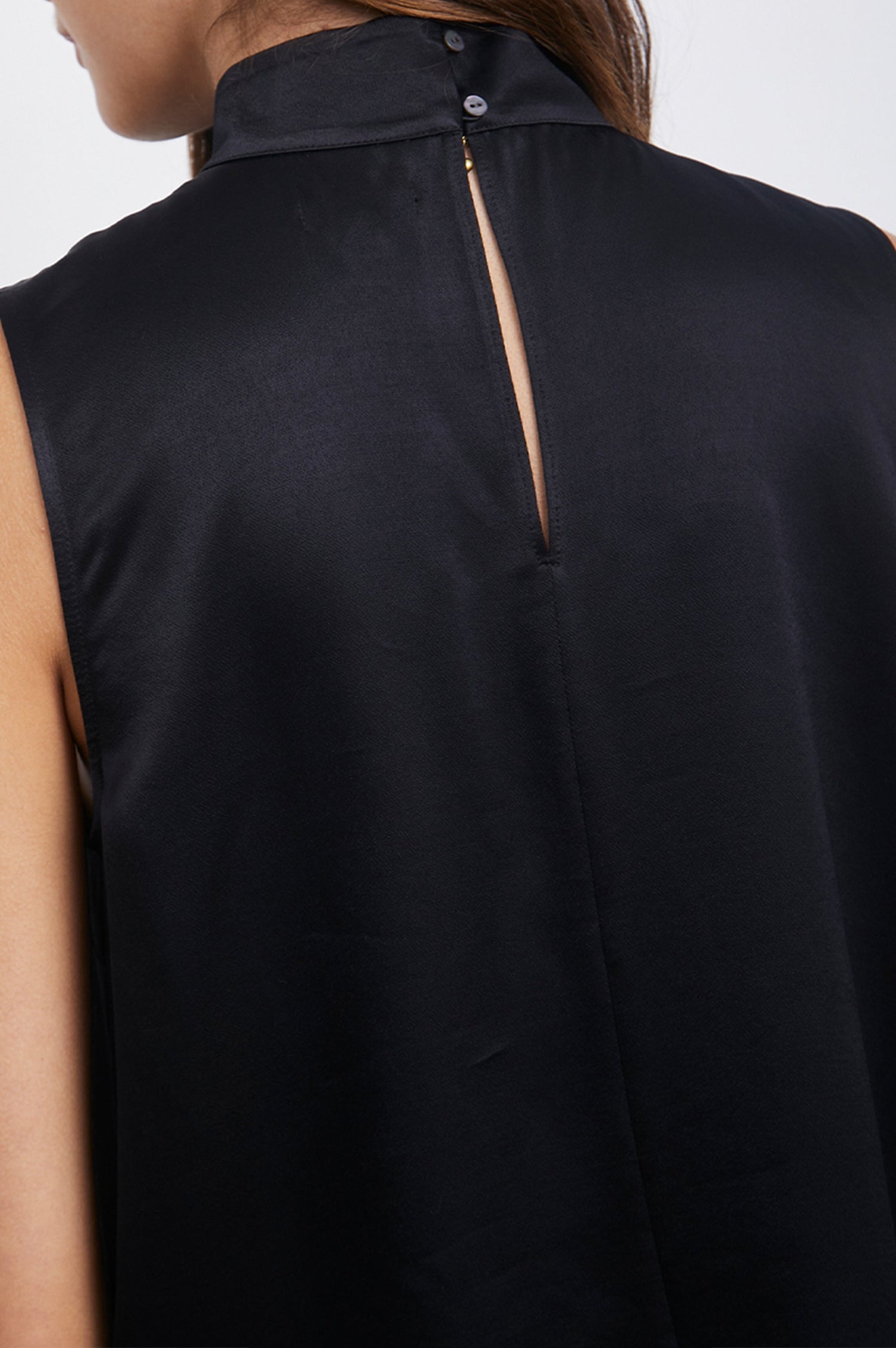 Yolie Sleeveless Tank Top with a Mock Neck and Two Button Back Neck Closure with a Keyhole in Black Colorway - Back View Featured on Model