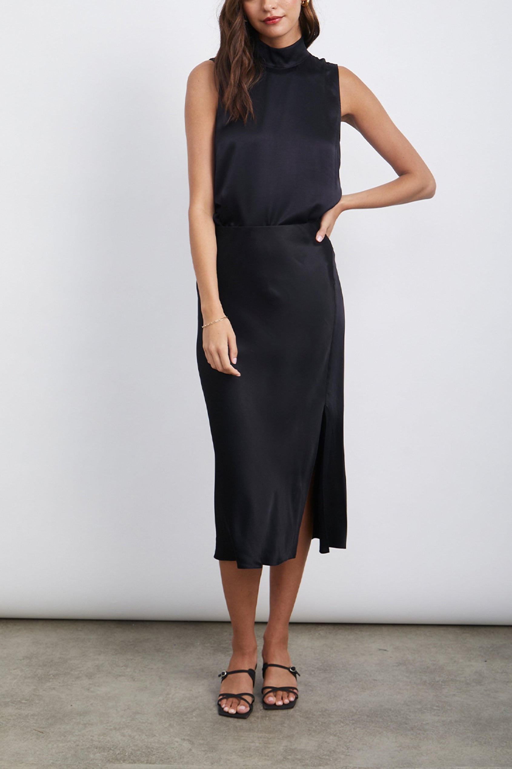 Yolie Sleeveless Tank Top with a Mock Neck and Two Button Back Neck Closure with a Keyhole in Black Colorway - Front Full Body View Featured on Model