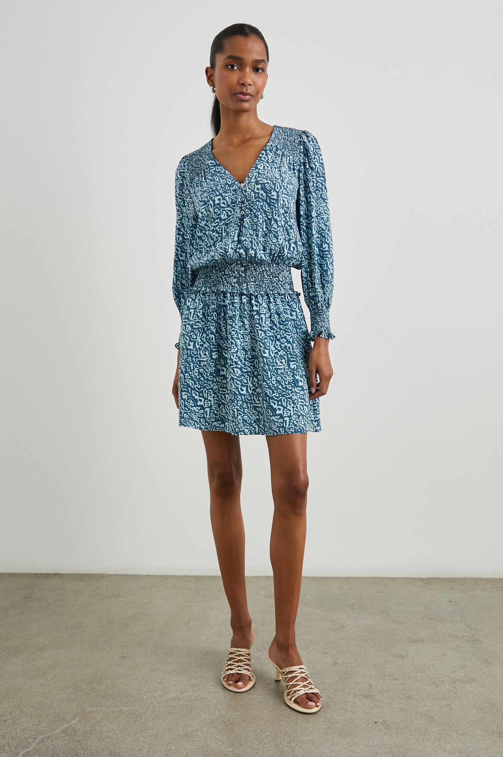 Zana Long-Sleeve Mini Dress with a V Neck, Smocked Cuffs and Waist, and Buttons Down the Bodice in Blue Havana Colorway, a Print in Blues - Front Full Body View Featured on Model