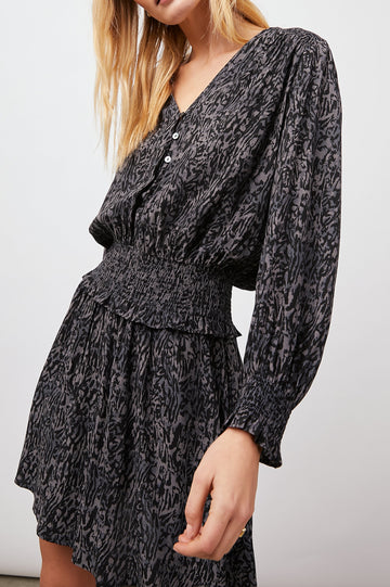 Zana Long-Sleeve Mini Dress with a V Neck, Smocked Cuffs and Waist, and Buttons Down the Bodice in Charcoal Abstract Animal Colorway, Animal Patterns in Charcoal and Black - Front View Featured on Model