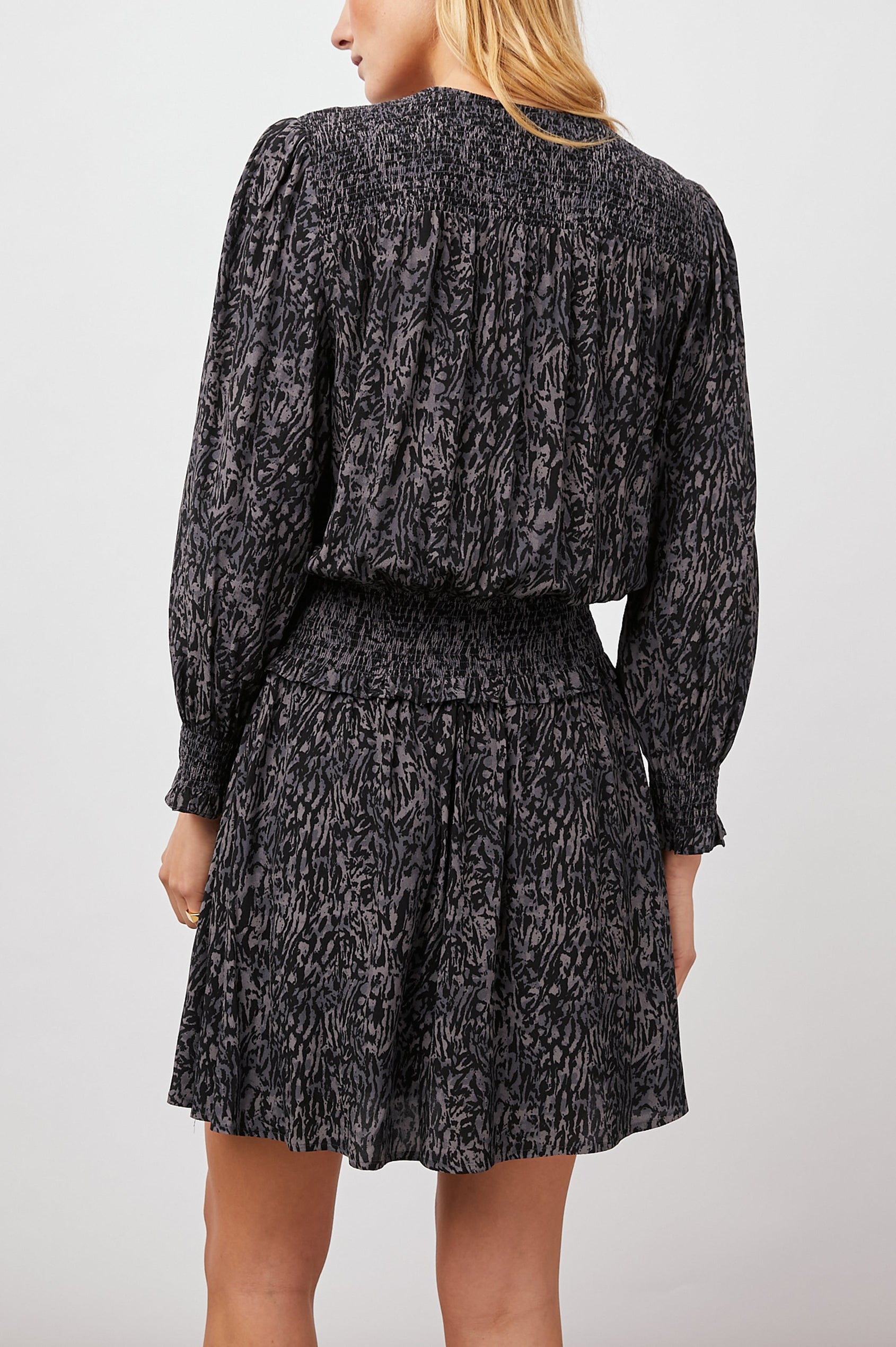 Zana Long-Sleeve Mini Dress with a V Neck, Smocked Cuffs and Waist, and Buttons Down the Bodice in Charcoal Abstract Animal Colorway, Animal Patterns in Charcoal and Black - Back View Featured on Model