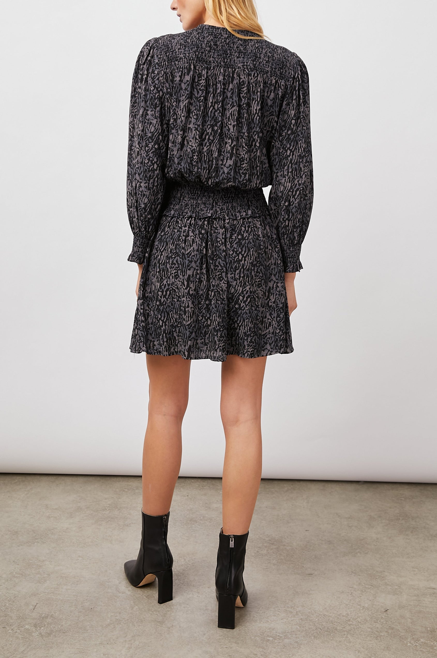 Zana Long-Sleeve Mini Dress with a V Neck, Smocked Cuffs and Waist, and Buttons Down the Bodice in Charcoal Abstract Animal Colorway, Animal Patterns in Charcoal and Black - Back Full Body View Featured on Model