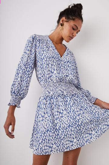 Zana Long-Sleeve Mini Dress with a V Neck, Smocked Cuffs and Waist, and Buttons Down the Bodice in Cobalt Static Leopard Colorway, a White and Cobalt Spotted Print - Front View Featured on Model
