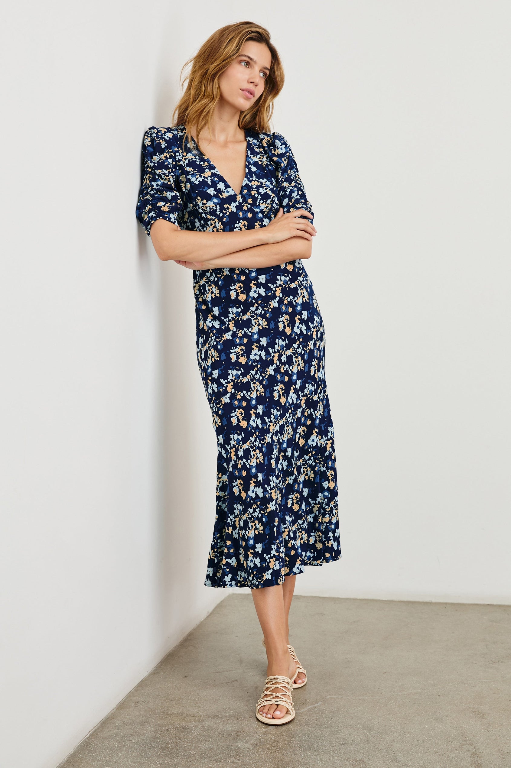 Zariah Midi Dress with Mid-Length Sleeves with Light Ruching, a Deep V Neck and an Empire Waist in Navy Flora Colorway, flowers in orange and blues on Navy - Front Full Body View Featured on Model