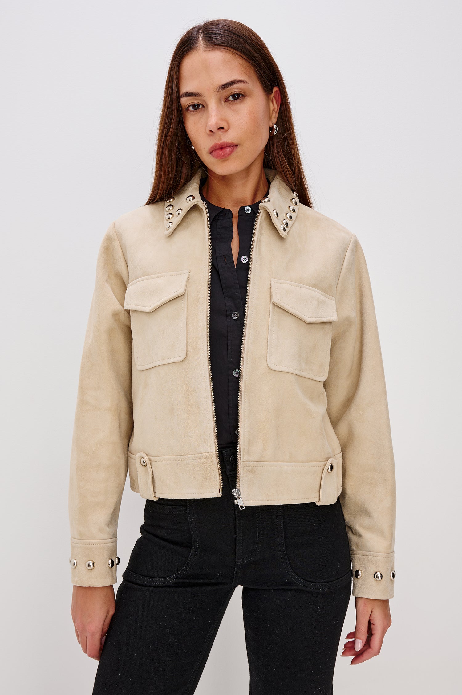 Zeta Boxy Moto Jacket in Suede With Metallic Studs, Collar, Front Zip Closure, Chest Flap Pockets, and Long Sleeves in Taupe Colorway - Front Upper Body View Featured on Model