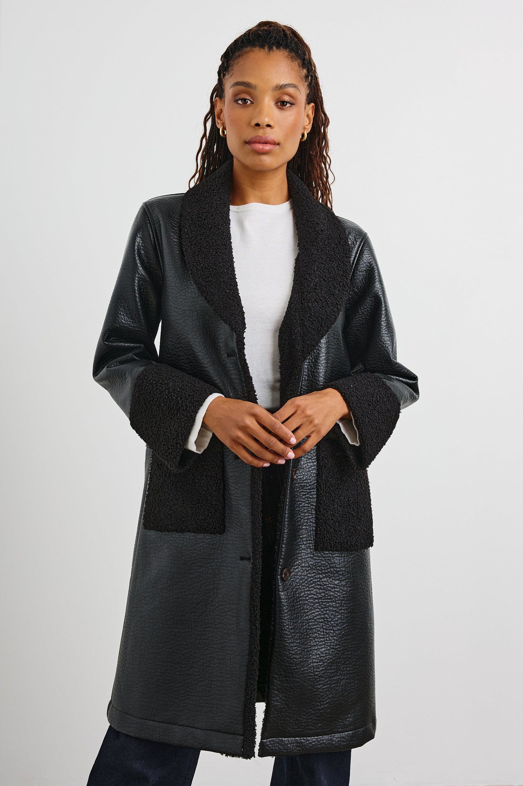 Zodiac Jacket with Button Closure Starting at the Mid-Chest and Two Front Patch Pockets in Black Shearling Colorway, with the Collar, Cuffs and Pockets in Faux Shearling - Front View Featured on Model