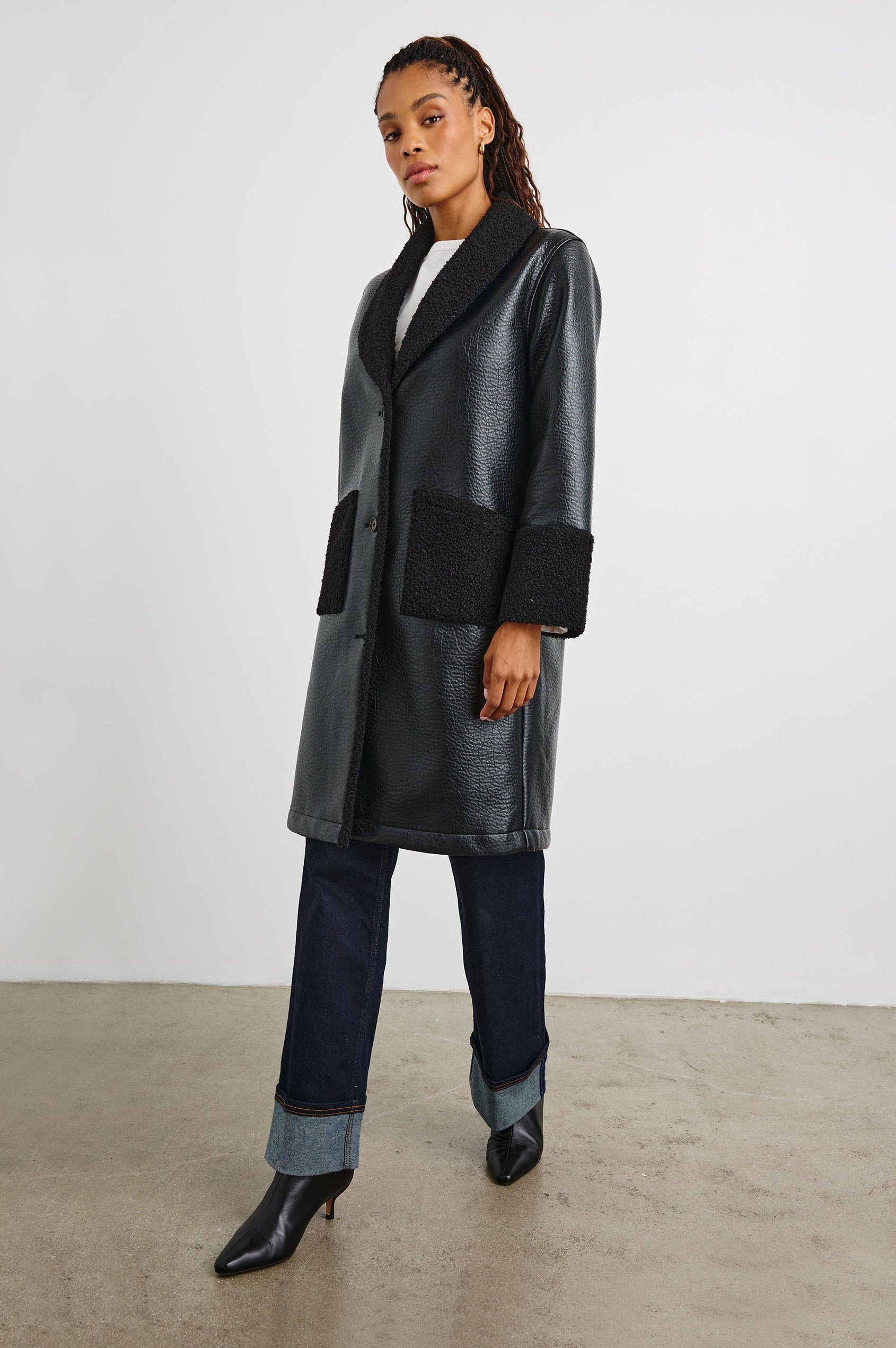 Zodiac Jacket with Button Closure Starting at the Mid-Chest and Two Front Patch Pockets in Black Shearling Colorway, with the Collar, Cuffs and Pockets in Faux Shearling - Front Full Body View Featured on Model