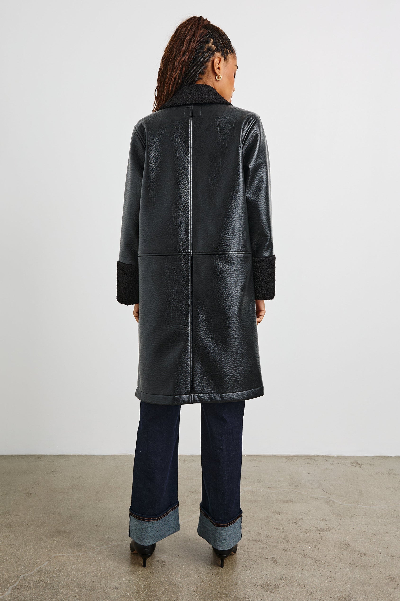 Zodiac Jacket with Button Closure Starting at the Mid-Chest and Two Front Patch Pockets in Black Shearling Colorway, with the Collar, Cuffs and Pockets in Faux Shearling - Back Full Body View Featured on Model