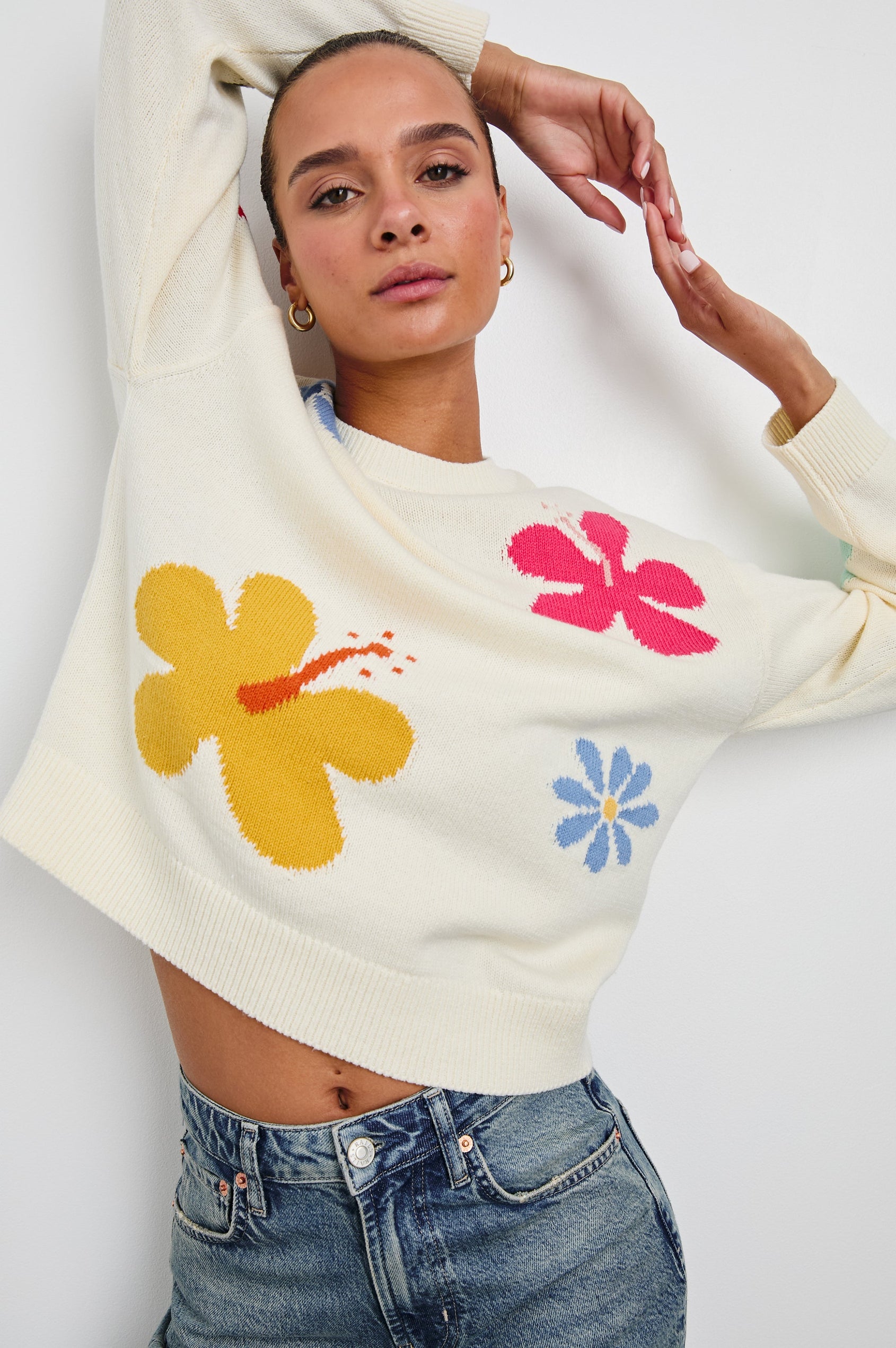 Zoey Long Sleeve Crew Neck Sweater With Multiple Colored Flowers In Colorway Ivory Hibiscus - Front View Model In Motion Featured On Model