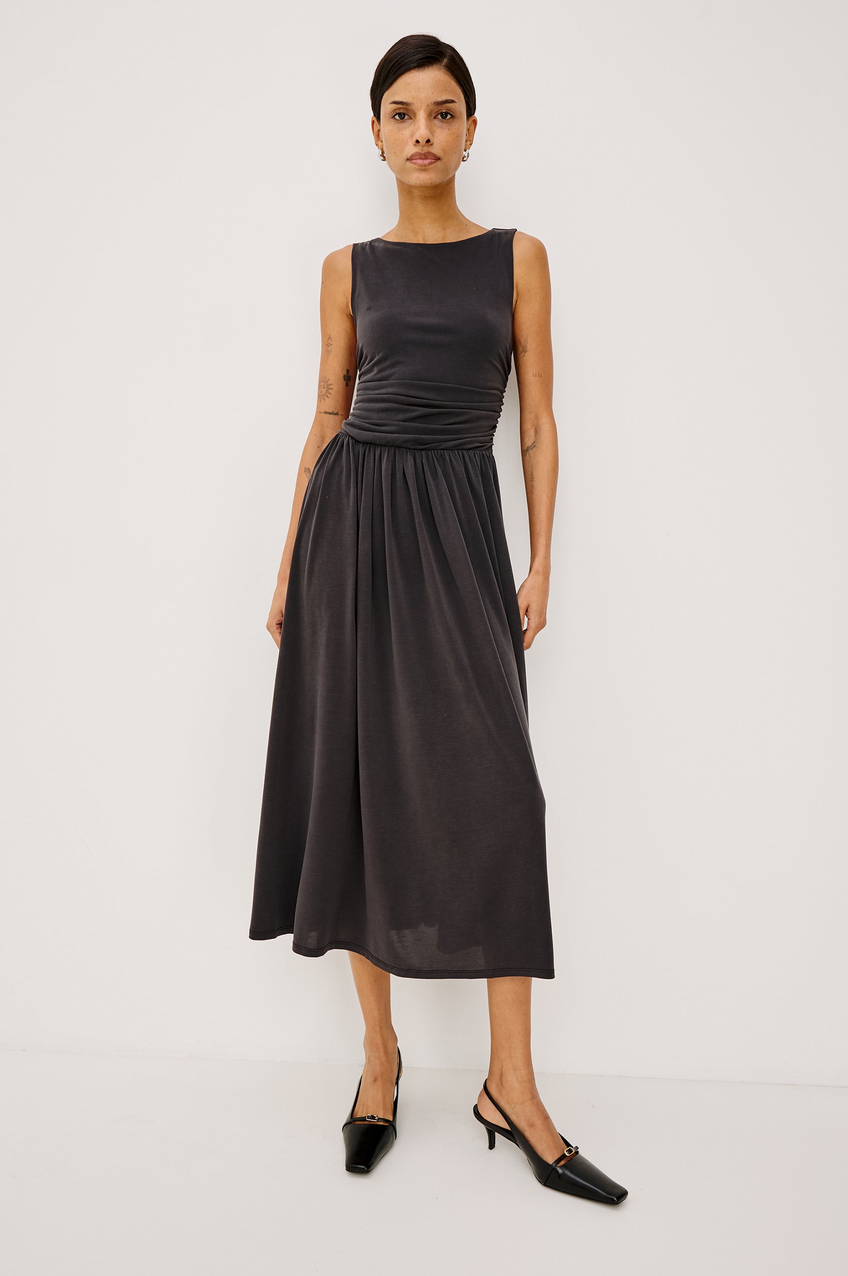Zora Maxi Dress in Peached Jersey With Fitted Ruched Bodice, Shirred A-Line Skirt, Sleeveless Cut, and Crew Neckline in Ash Colorway - Full Body Front View Featured on Model