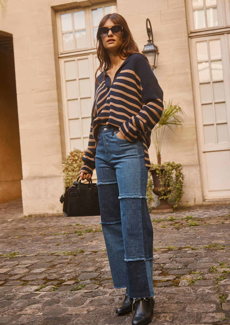 FULL BODY EDITORIAL IMAGE OF MODEL WEARING HARRIS SWEATER AND GETTY CROP WIDE LEG JEAN.