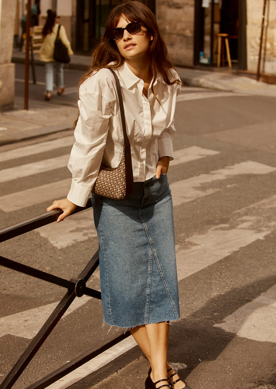 FULL BODY EDITORIAL IMAGE OF MODEL WEARING HIGHLAND SKIRT AND ANABELLE TOP