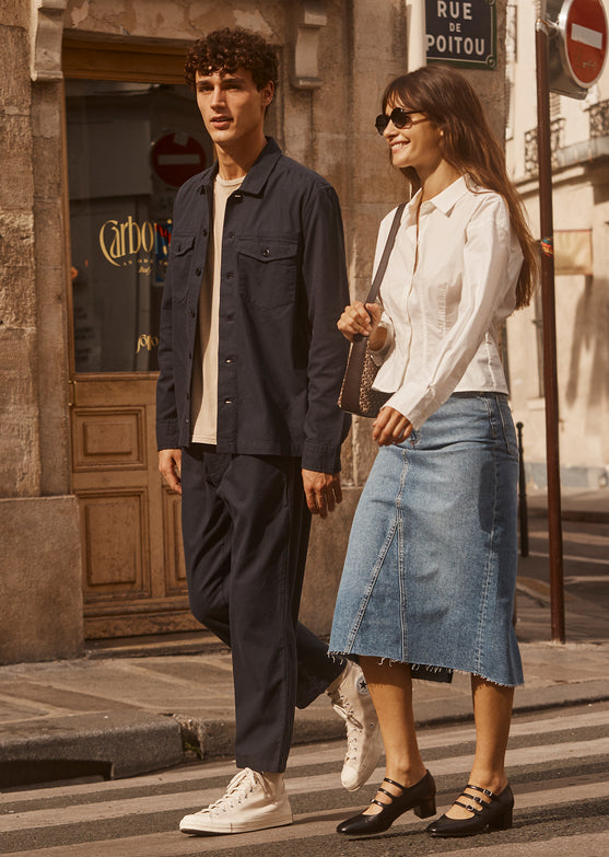 EDITORIAL IMAGE OF TWO MODELS. FIRST MODEL IS WEARING KEROUAC SHIRT JACKET AND MARCELLUS PANT. SECOND MODEL IS WEARING ANABELLE TOP AND HIGHLAND SKIRT. 