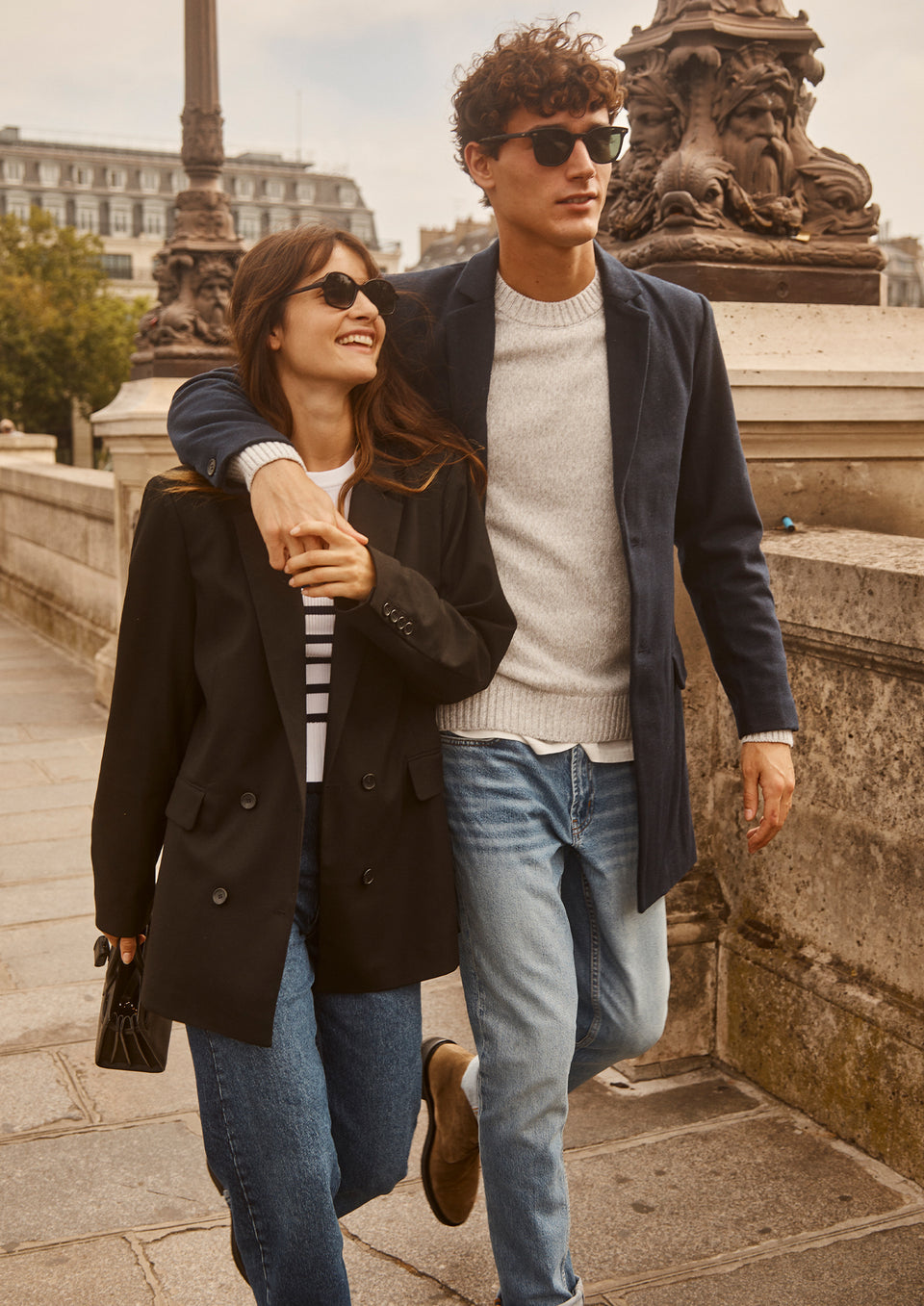 EDITORIAL IMAGE OF TWO MODELS. FIRST MODEL IS WEARING JAC BLAZER, GEMMA SWEATER, AND TOPANGA STRAIGHT JEAN. SECOND MODEL IS WEARING LARK COAT, DONOVAN SWEATER, AND CLAYTON SLIM STRAIGHT JEAN.