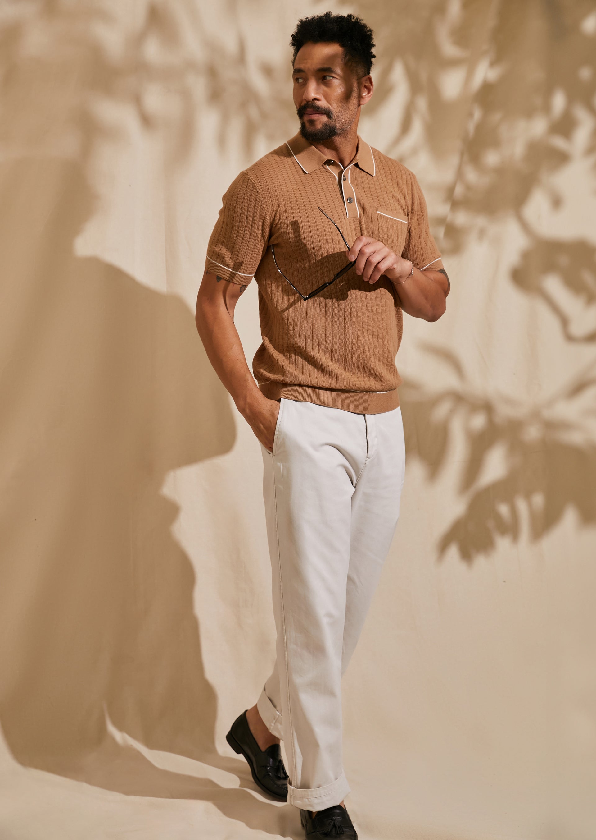 FRONT FULL BODY EDITORIAL IMAGE OF MODEL WEARING HARDY POLO SHIRT AND GARRETT PANT