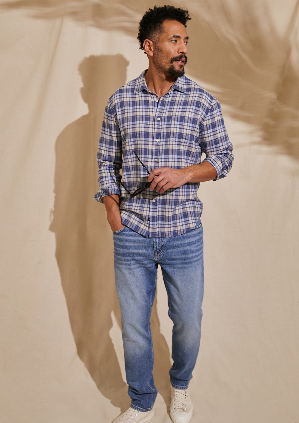 FRONT FULL BODY EDITORIAL IMAGE OF MODEL WEARING WYATT SHIRT AND CLAYTON SLIM STRAIGHT JEANS