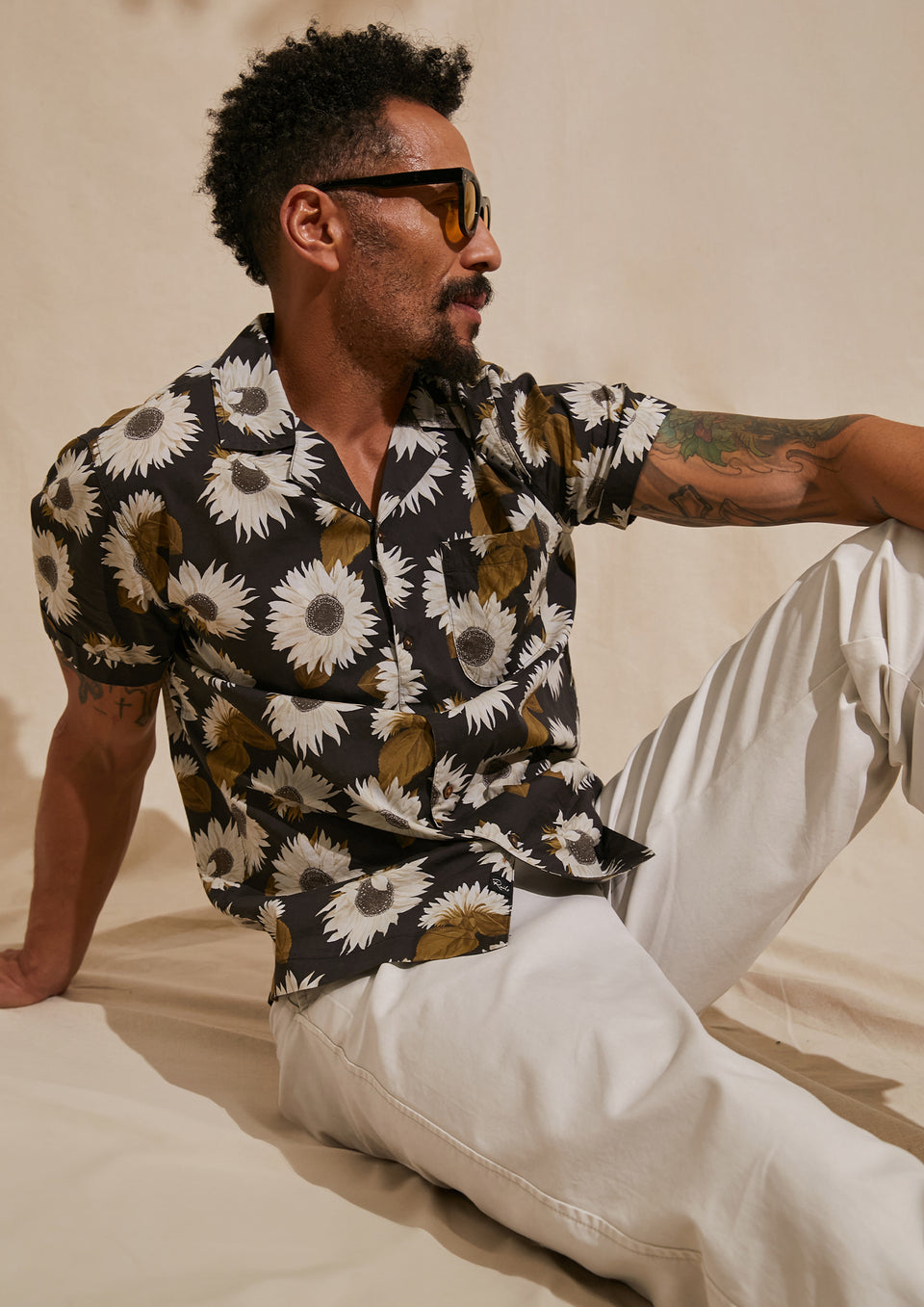 EDITORIAL IMAGE OF MODEL SITTING DOWN WEARING MORENO SHIRT AND GARRETT PANT