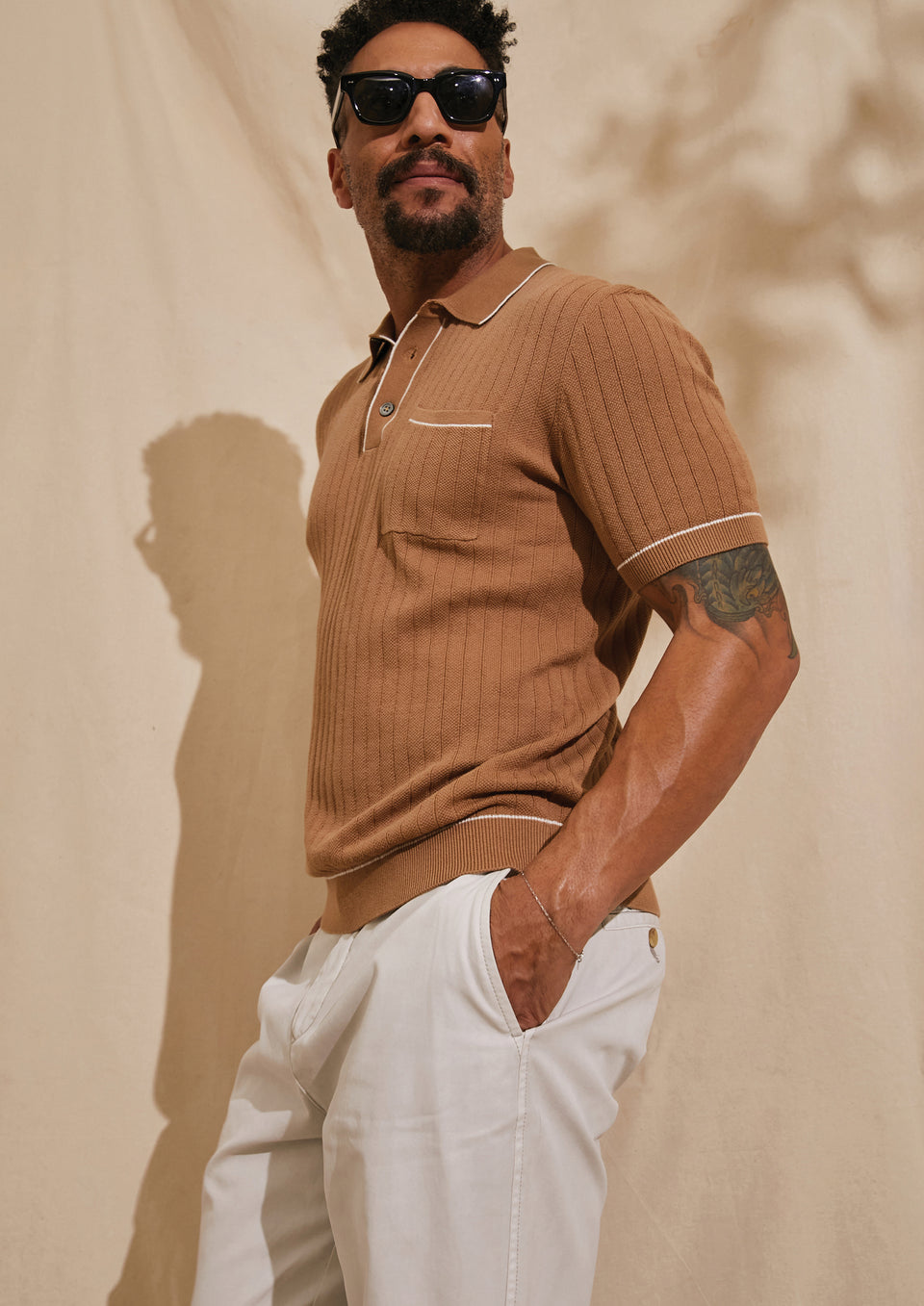 SIDE EDITORIAL IMAGE OF MODEL WEARING HARDY POLO SHIRT AND GARRETT PANT