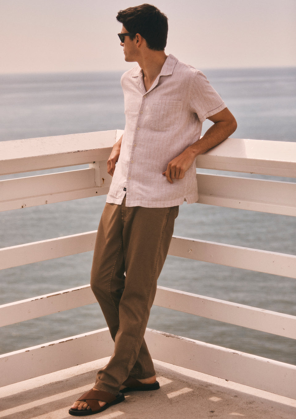 Side full body editorial image of model wearing Waimea Shirt