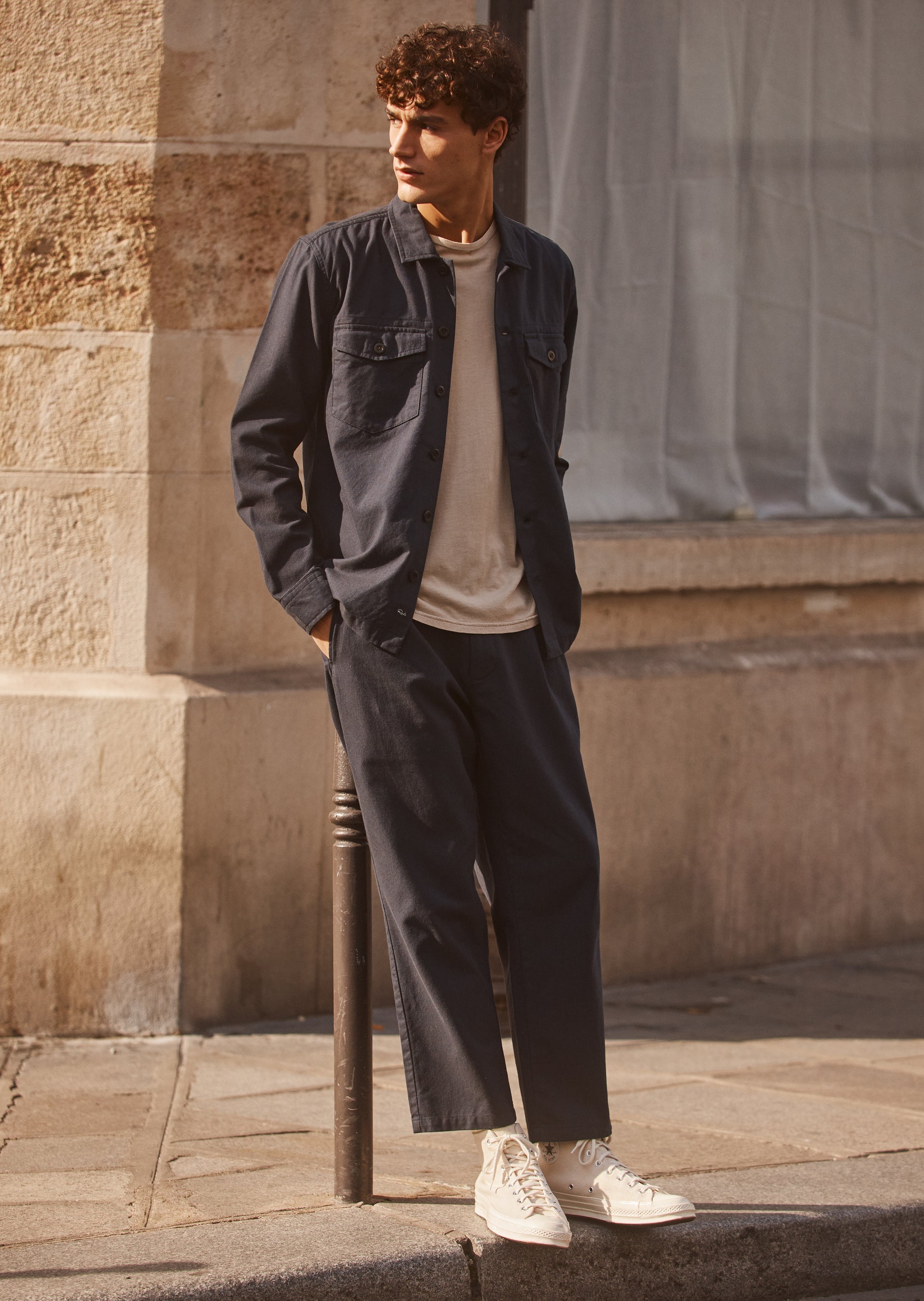 FULL BODY EDITORIAL IMAGE OF MODEL WEARING KEROUAC SHIRT JACKET AND MARCELLUS PANT