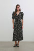(Video): Zariah Dress shown on a model to showcase the rayon crepe material, dainty floral print, deep v-neckline, short sleeves, and midi length. Full Body View Featured on Model.