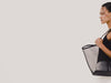 Roma Tote in Mesh With Spacious Trapeze Shape, Leather Trim, and Top Handles in Black Colorway - Video - Side View Featured on model.