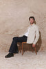 Rhett is a collared snap front shirt jacket with two chest pockets, side pockets and adjustable sleeve plackets in Stone colorway. Side sitting view video shown on model.