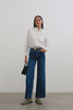 (Video): Stina Shirt shown on a model to showcase the lightweight 100% cotton material, classic shirting details, and fitted silhouette. Full Body View Featured on Model.