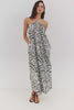 Video of Model wearing a black and white patterned maxi halter dress posing in a video to showcase her outfit.