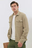 The Wells is a collared button front shirt jacket with contrast brown buttons and two chest pockets in Barley colorway. Full body walking video shown on model.