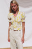 Fontaine Cropped Top in Cotton Poplin With Fitted Smocked Body V-Neckline With Center-Front Ties Short Puff Sleeves Rufle Trim and Peplum Hem in Tossed Daffodils Colorway - Full Body Front View Featured on Model - Video