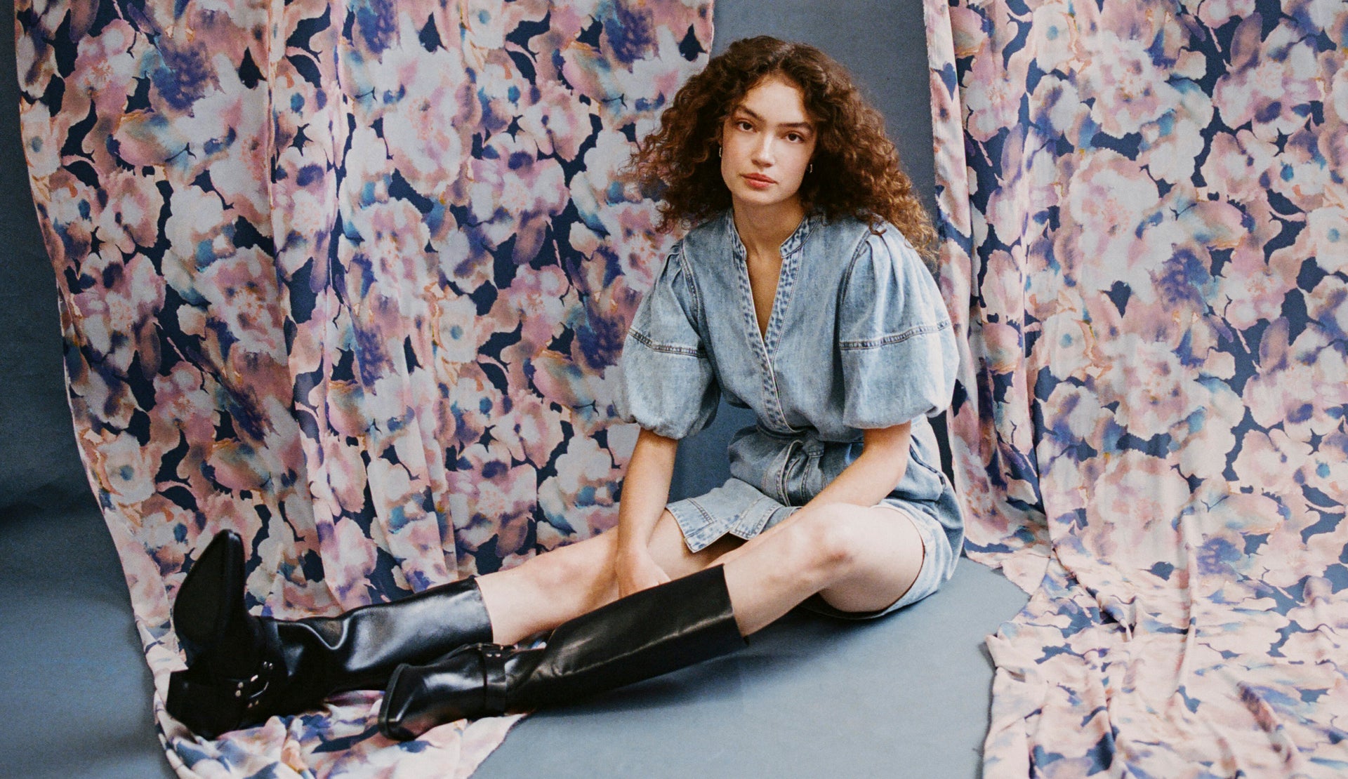 EDITORIAL IMAGE OF MODEL SITTING WEARING KINGSLEY DRESS