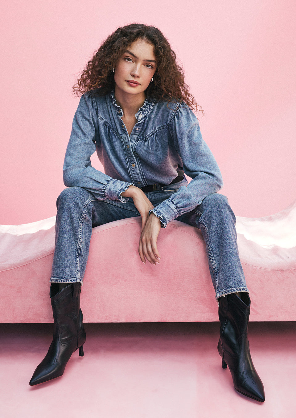EDITORIAL IMAGE OF MODEL SITTING WEARING ALANNA SHIRT AND TOPANGA STRAIGHT JEANS