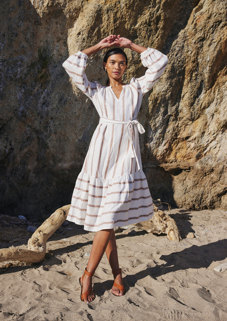 FRONT FULL BODY EDITORIAL IMAGE OF MODEL ON THE BEACH WEARING VITTORIA DRESS IN COCONUT STRIPE