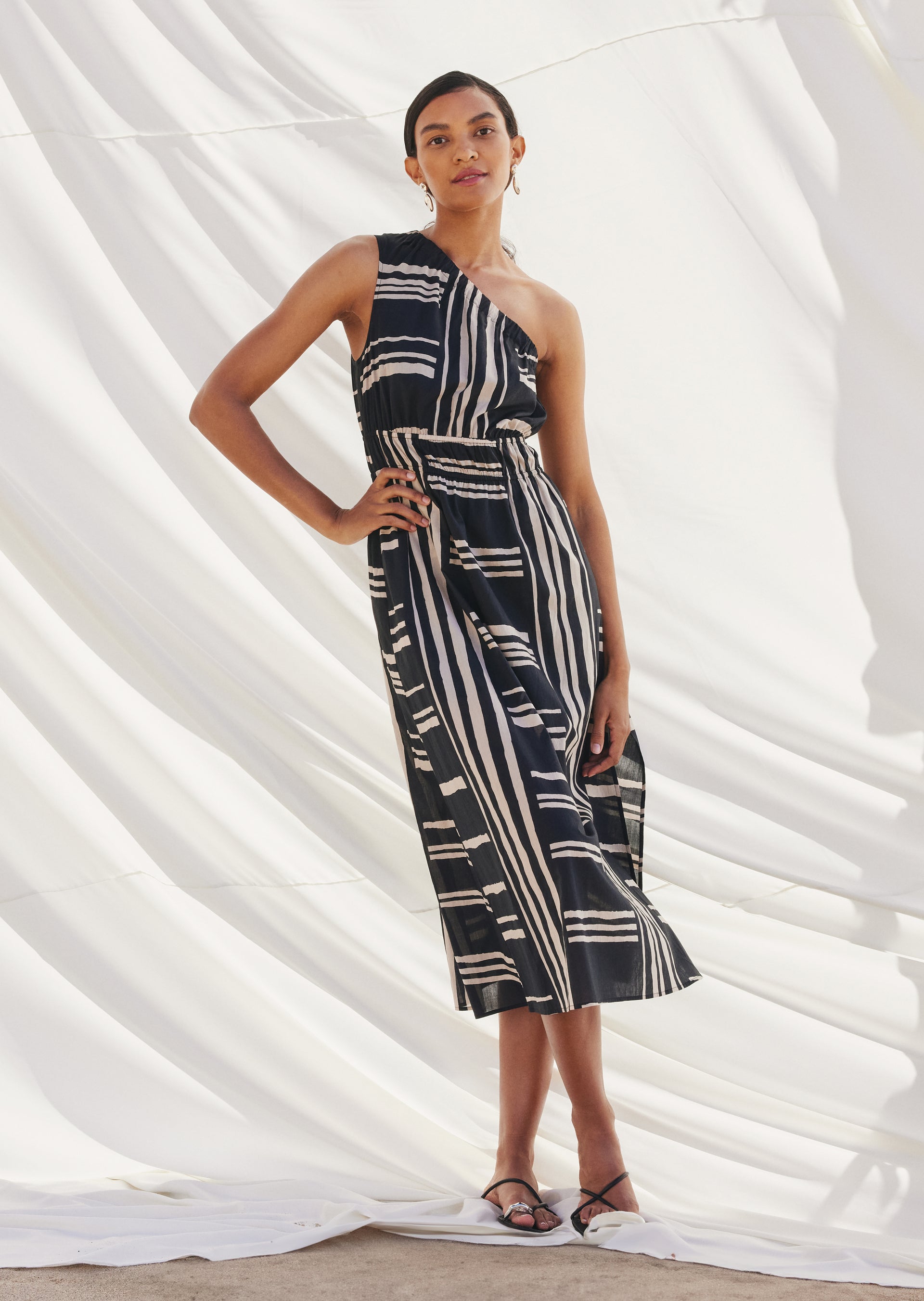 FRONT FULL BODY EDITORIAL IMAGE OF MODEL WEARING THE SELANI DRESS IN ISLAND STRIPE