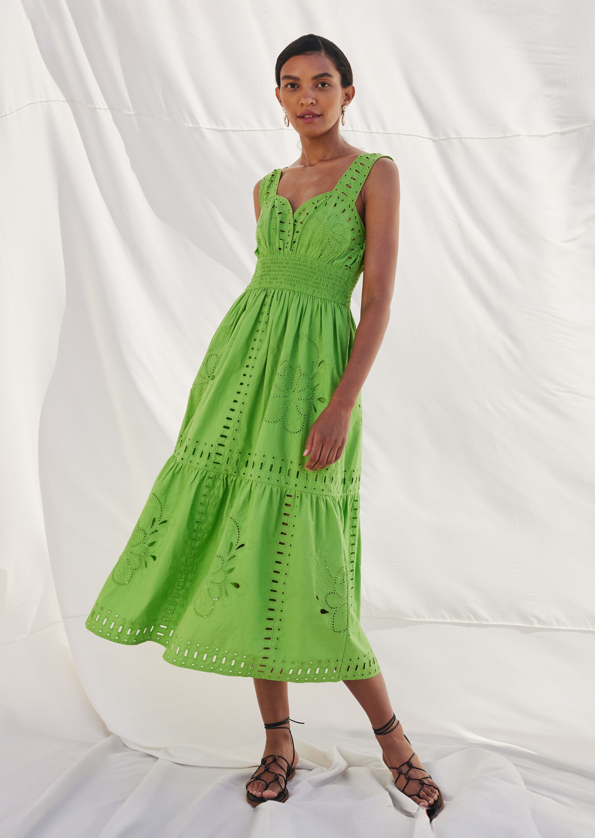 FRONT FULL BODY EDITORIAL IMAGE OF MODEL WEARING FAWN DRESS IN ISLAND GREEN