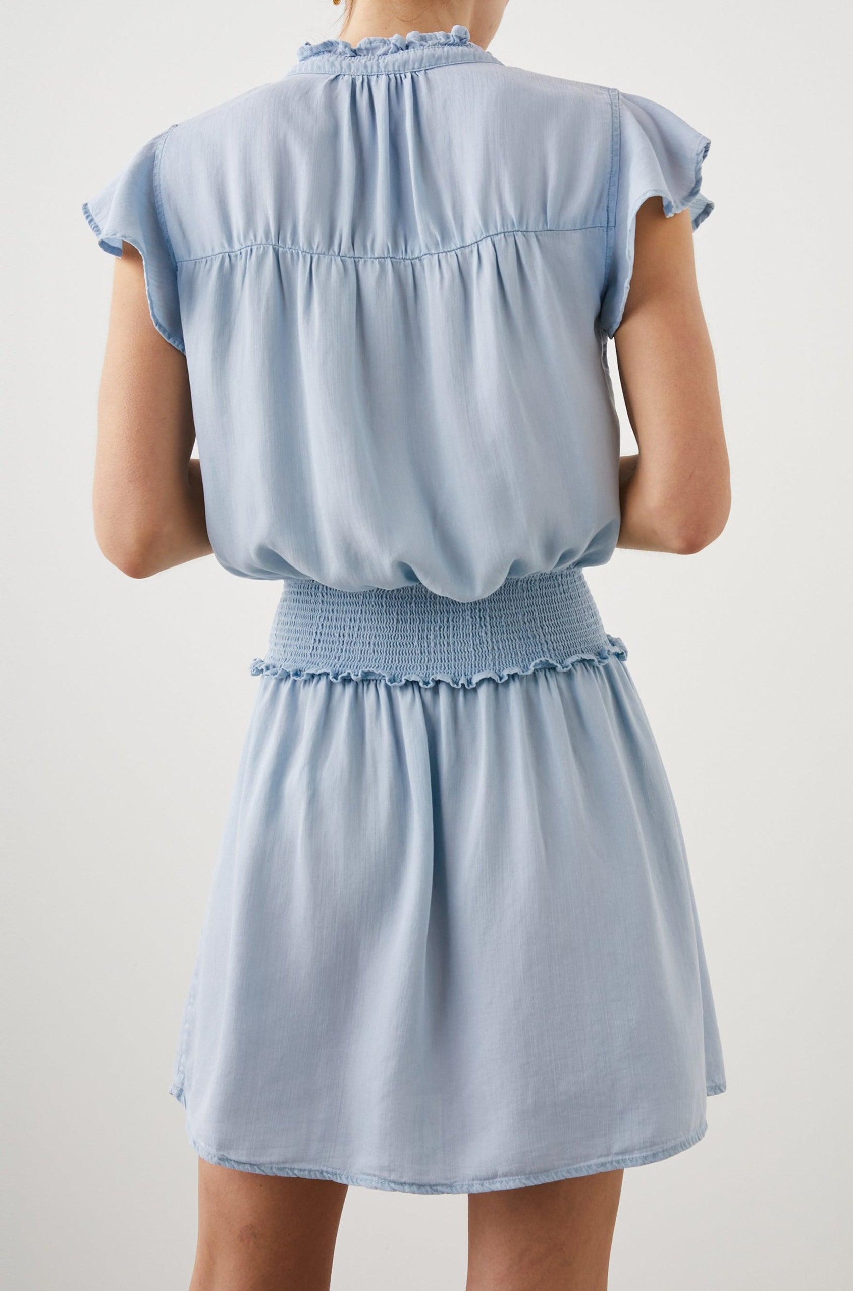 Amina Short Sleeve Mini Dress with Flutter Sleeves, a Ruffled Collar with Ruching, a Button Placket, and a Shirred Waist in Light Vintage Colorway - Back View Featured on Model 