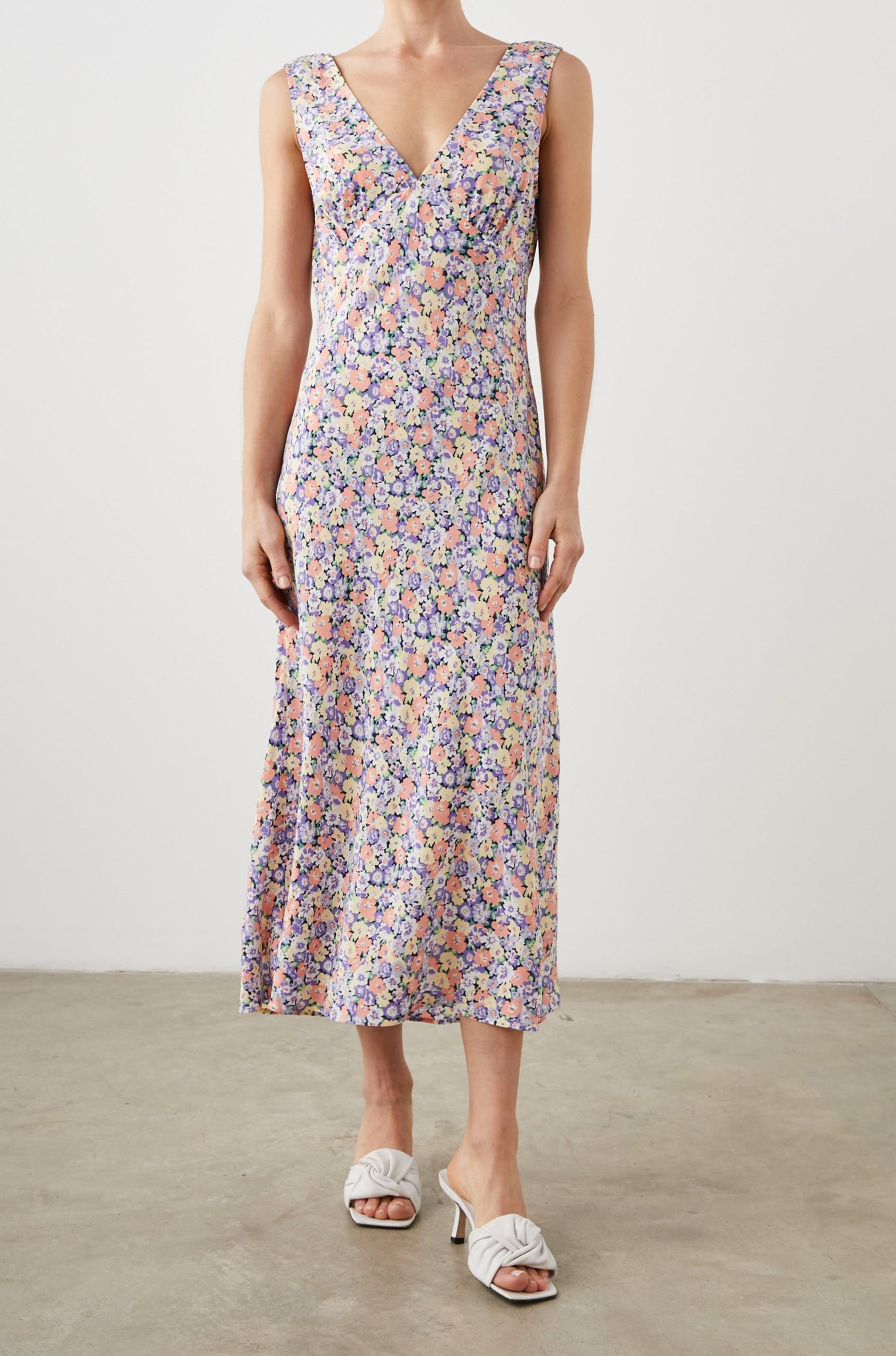 Audrina Sleeveless Midi Dress with Wide Shoulder Straps, a Deep V Neck and V-Back, and an Empire Waist in Posy Field Colorway, with flowers in yellows, purples and oranges - Front Full Body View Featured on Model 