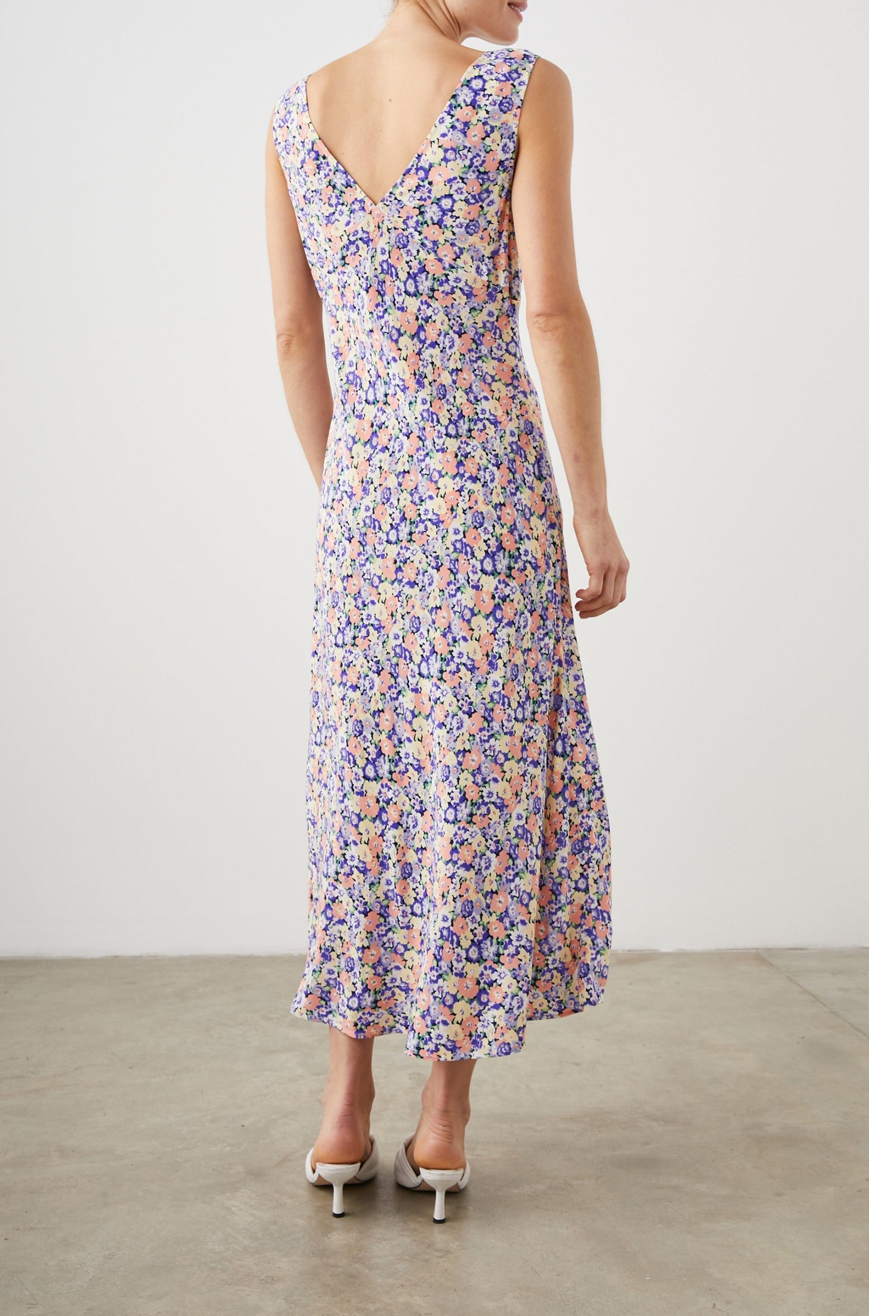 Audrina Sleeveless Midi Dress with Wide Shoulder Straps, a Deep V Neck and V-Back, and an Empire Waist in Posy Field Colorway, with flowers in yellows, purples and oranges - Back Full Body View Featured on Model 