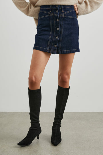 Canyon Denim Mini Skirt with a Full Button Front, Belt Loops, Two Front Pockets and Two Back Patch Pockets in Midnight Blues Colorway - Front View Featured on Model