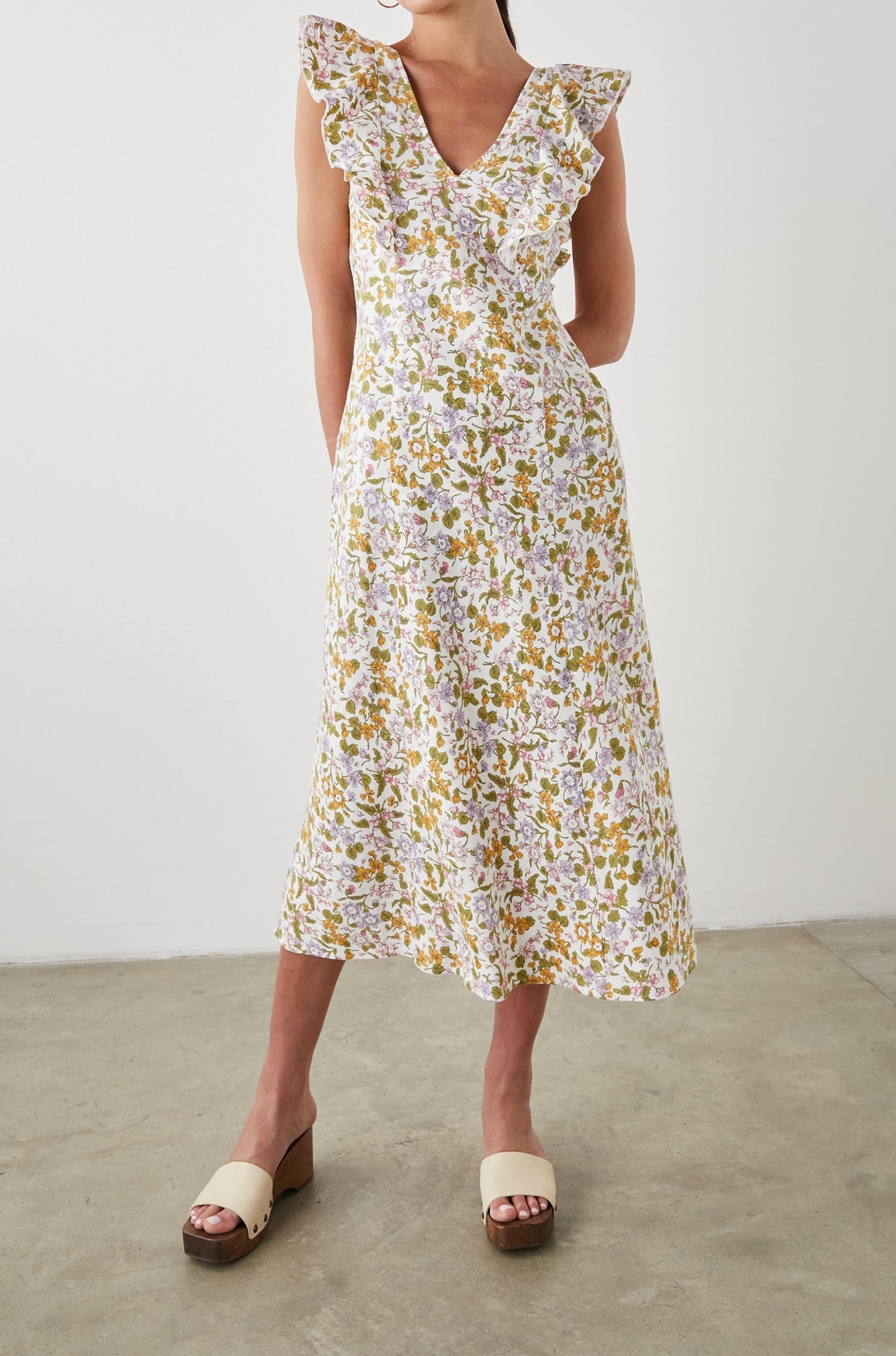 Constance Short Sleeve Midi Dress with Flutter Sleeves, a V Neck, and Cross Ties Across the Mid to Upper Back in Tansy Colorway, Brown, Orange, Purple, Pink and Green on White - Front Full Body View Featured on Model 