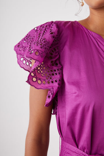 Gia Short-Sleeve Midi Dress with Flutter Sleeves, a V Neck, a Fabric Tie at the Waist, a Tiered Skirt and Eyelet Detail on the Sleeves and Hem in Berry Colorway - Front View Featured on Model