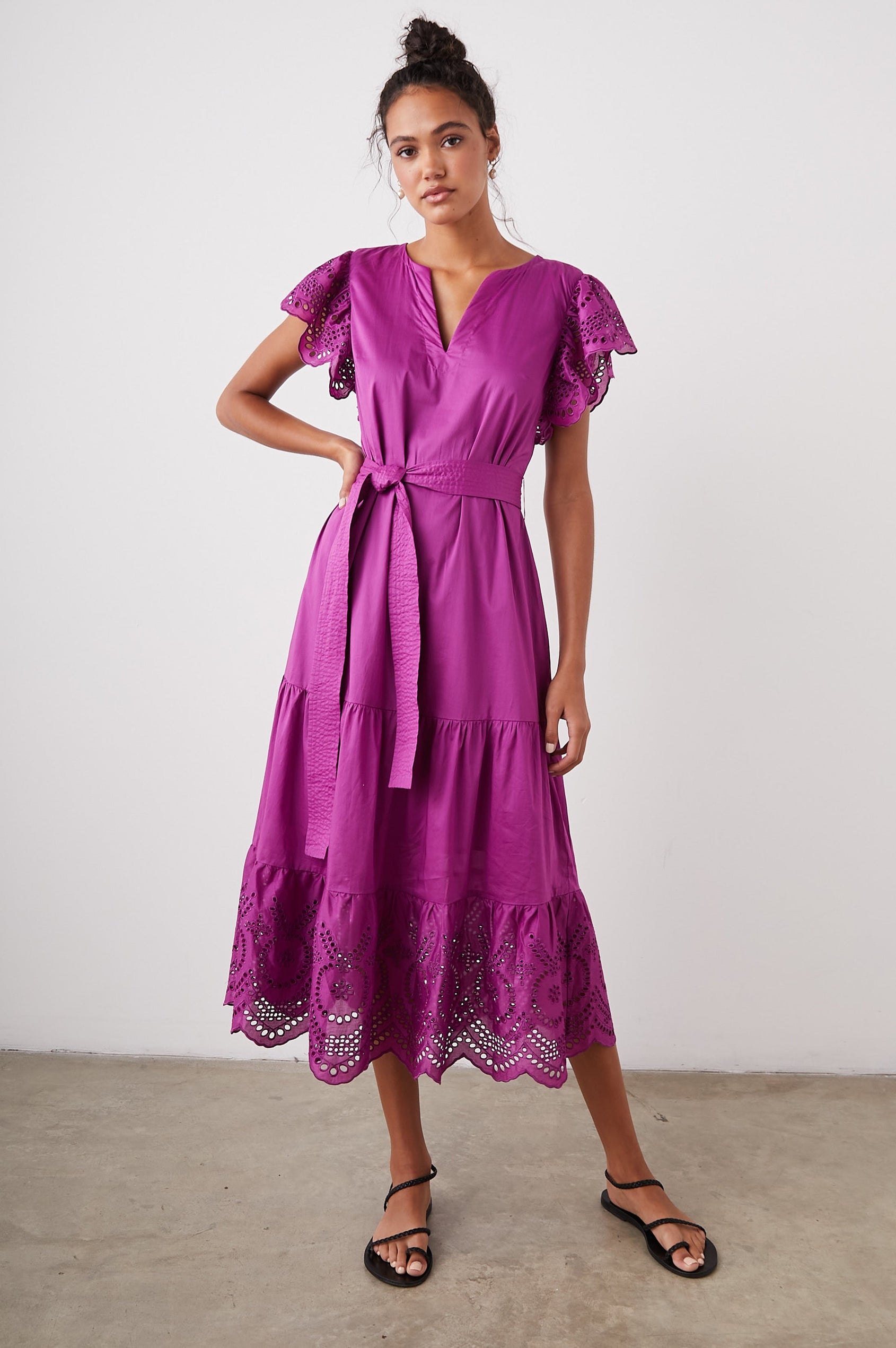 Gia Short-Sleeve Midi Dress with Flutter Sleeves, a V Neck, a Fabric Tie at the Waist, a Tiered Skirt and Eyelet Detail on the Sleeves and Hem in Berry Colorway - Front Full Body View Featured on Model