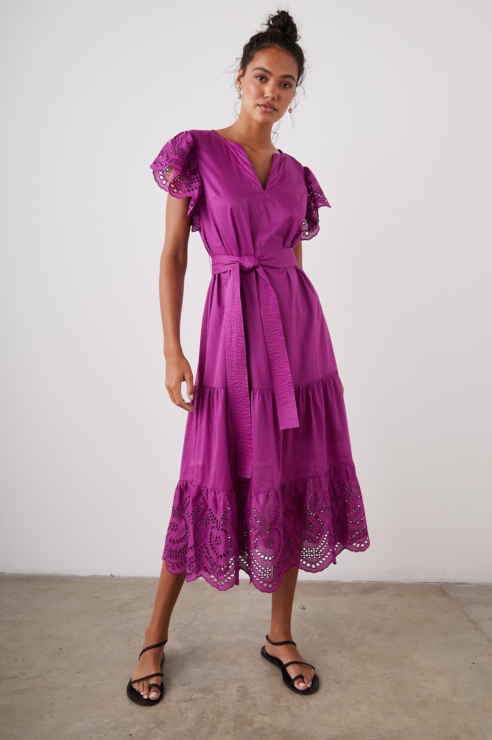 Gia Short-Sleeve Midi Dress with Flutter Sleeves, a V Neck, a Fabric Tie at the Waist, a Tiered Skirt and Eyelet Detail on the Sleeves and Hem in Berry Colorway - Front Full Body View Featured on Model