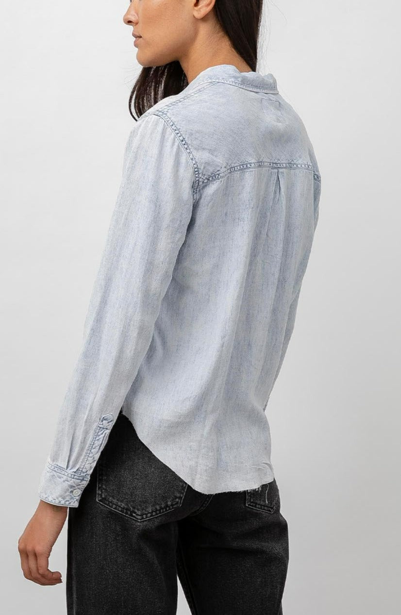 Ingrid Raw Hem, Long Sleeve Denim Button Up with a Chest Patch Pocket in Light Acid Wash Colorway - Back View Featured on Model